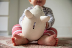 Baby mit Sparschwein